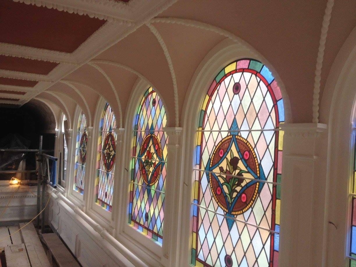 Historic church during restoration with stained glass windows, Essex